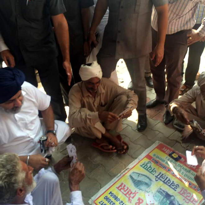 All’s well in Badal: Sukhbir plays cards with villagers