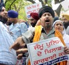 Sikh activists raising slogans outside Jammu & Kashmir House in protest against the killing of a Sikh youth in J&K police firing, in New Delhi on Friday. Tribune photo: Manas Ranjan Bhui