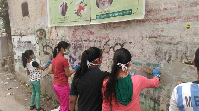 MAD volunteers beautify shabby wall