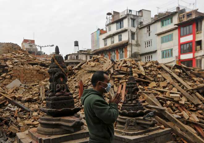 Angry Nepalis dig into rubble themselves
