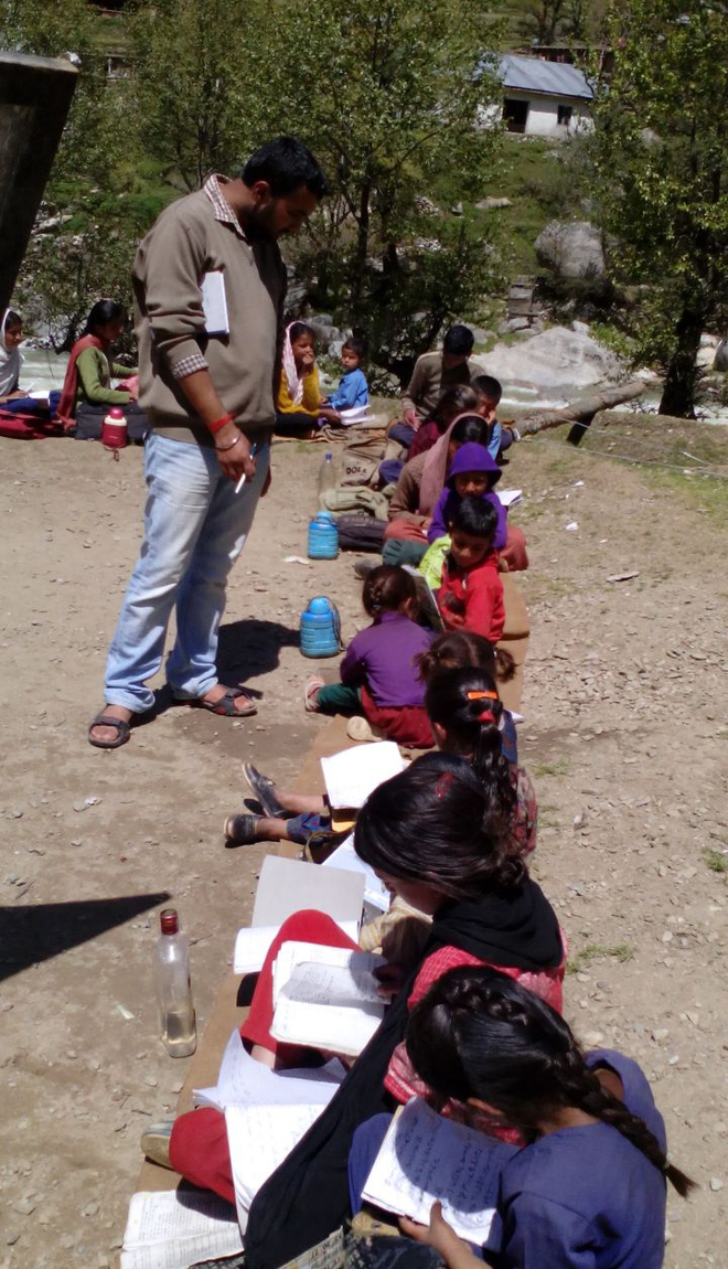 Sunshine or rain, students of this Doda school attend classes in open