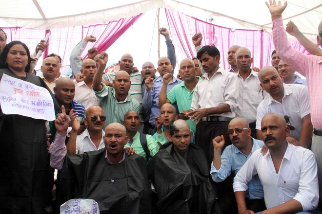 Protesting SC, ST category teachers shave heads