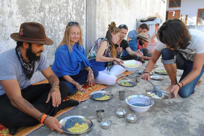 Foreign tourists served food by local family