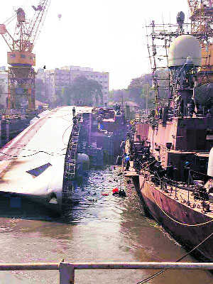 2 dead as warship tips over at dock
