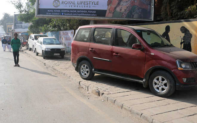 Pedestrians forced to walk on roads as footpaths blocked - The Tribune