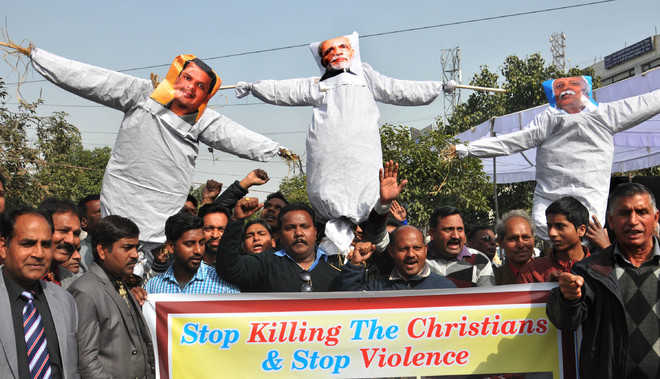 Christian associations up in arms, burn effigies of PM, RSS chief