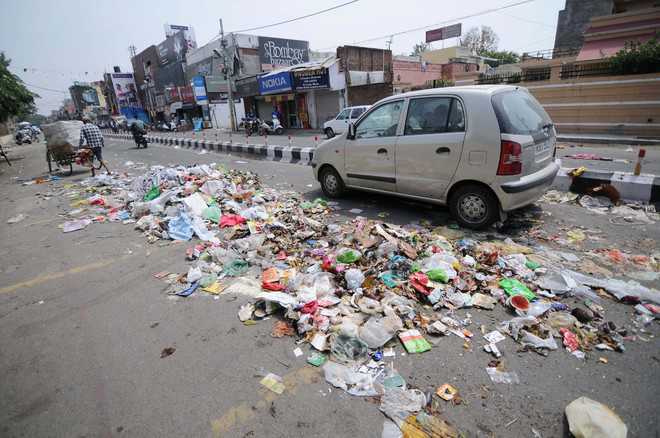 MC employees go on indefinite strike, dump garbage on roads