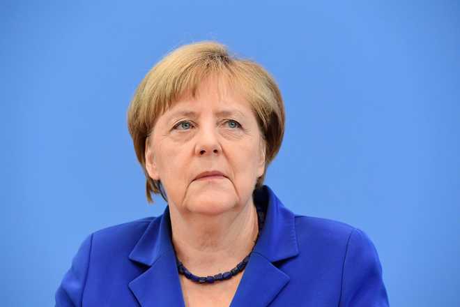 Defiant Merkel defends refugee stance after spate of attacks