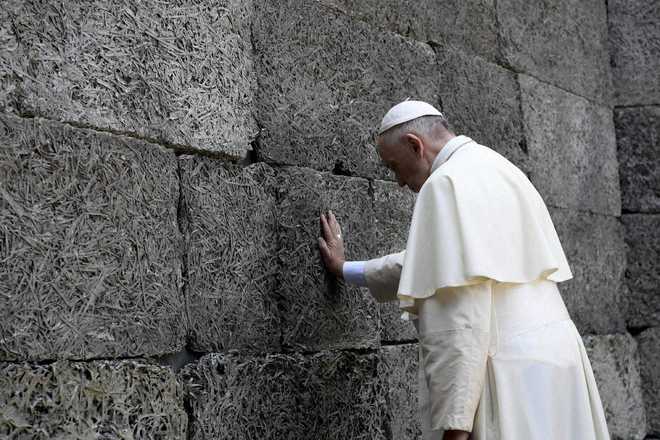 Pope visits Auschwitz, asks God to forgive “so much cruelty”