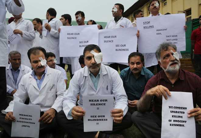 With bandage on eye, docs protest