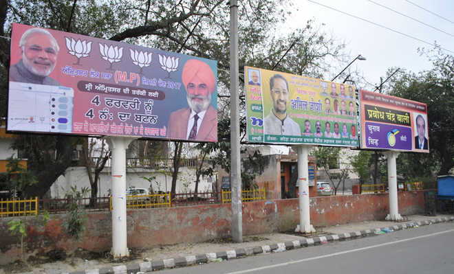 Hoardings, posters, political flags dot the city