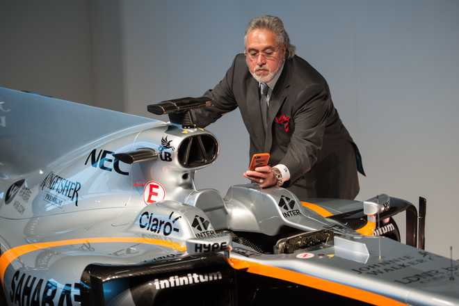 Wanted Mallya appears in UK for launch of F1 car