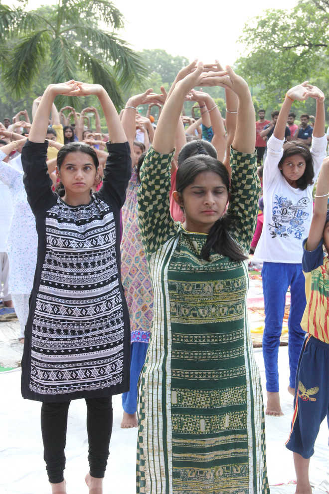 Students, residents come together to celebrate Int’l Yoga Day