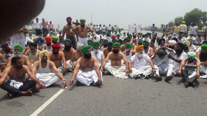Farmers go shirtless in protest against Yoga Day