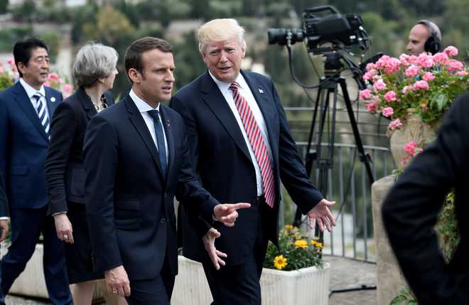 Trump, escaping domestic woes, visits France’s Macron