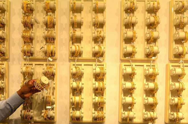 Gold futures fall Rs 94 on weak global cues