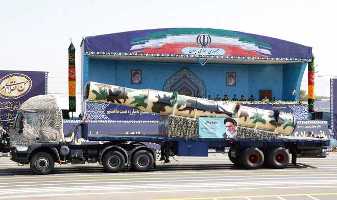 In defiance to US, Iran unveils new missile during parade