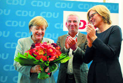 After win, Merkel  faces coalition test