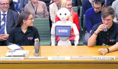 Robot’s debut in UK Parliament invites ‘Maybot’ mockery