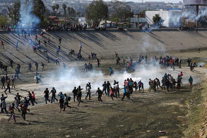 US fires teargas into Mexico to repel migrants, closes border gate