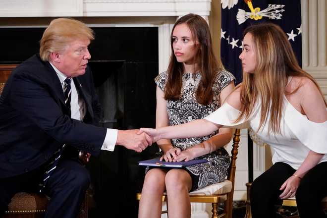 Trump pledges to find long-term solution to gun violence