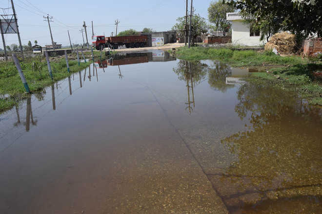 Village road turns into pond, residents blame officials