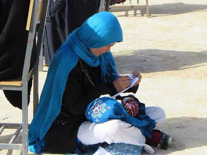 Afghan mum cradling baby during university exam goes viral