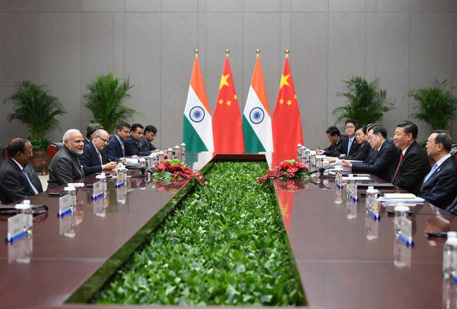 Modi and Xi discuss ways to further strengthen ties in Qingdao