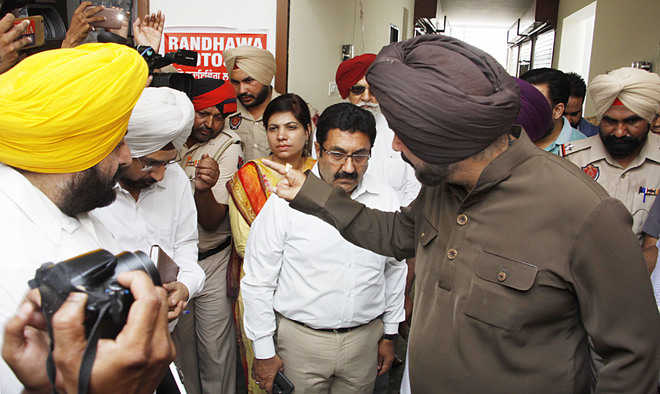Sidhu talks tough with officials