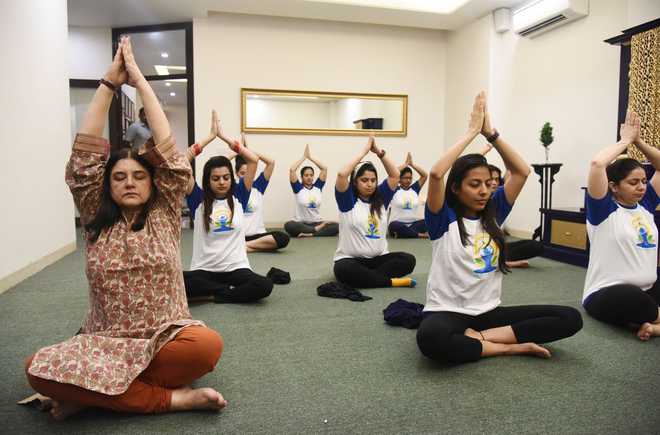 Maneka performs prenatal yoga asanas with pregnant women