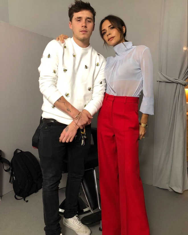 Victoria Beckham attends Paris Fashion Week with son