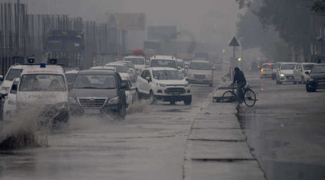 Rain pours misery on most city roads