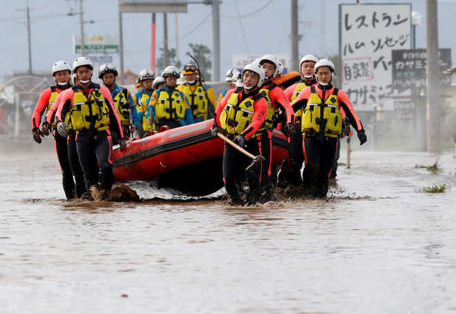 Japan looks for missing after typhoon, warned of mudslides