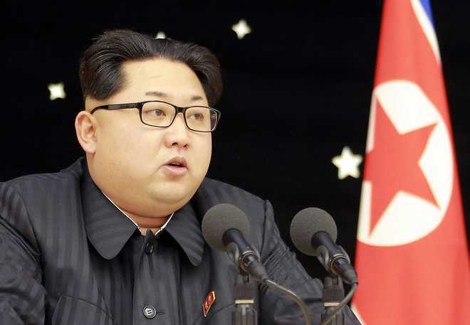 Kim vows to fight US sanctions; visits sacred North Korean peak