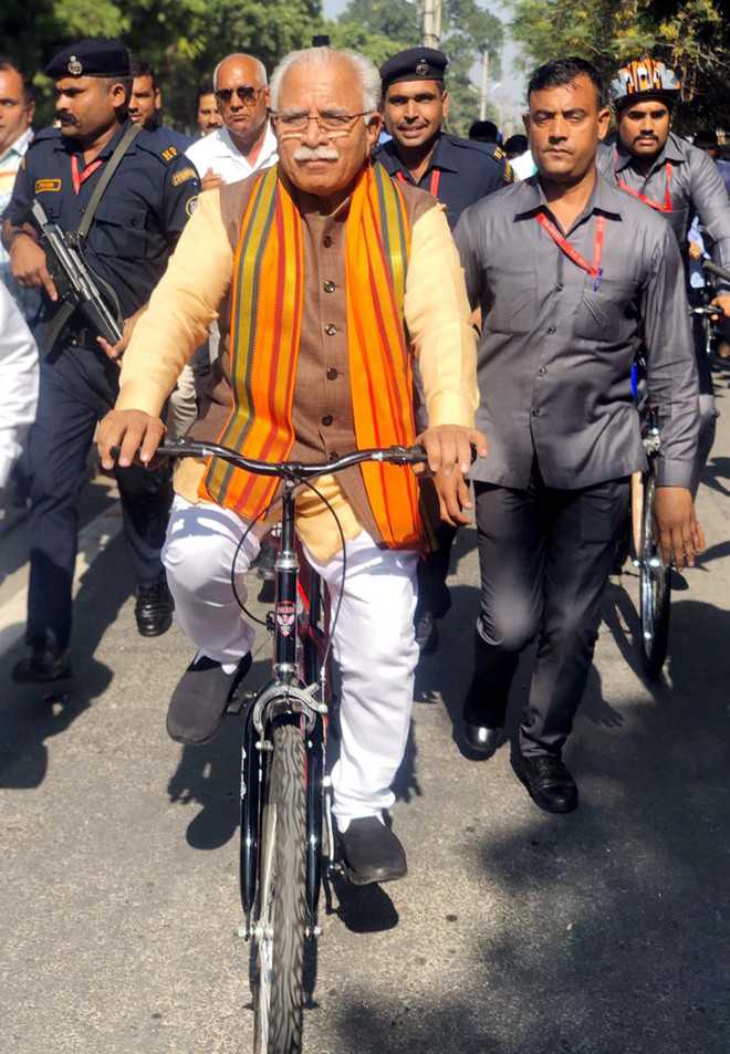 Khattar takes train to Karnal, rides cycle to polling booth