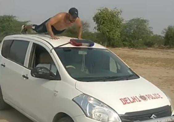 Shirtless man does push-ups on Delhi Police car, video viral