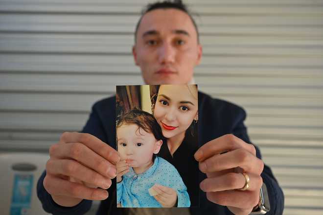 Australian father struggles to get son and Uighur wife back from China
