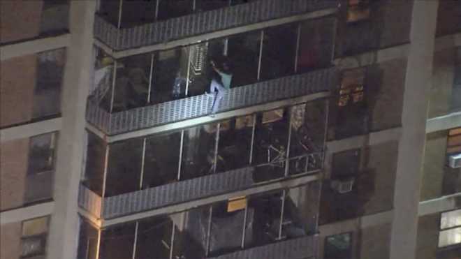 Man scales down side of 19-storey building to escape fire