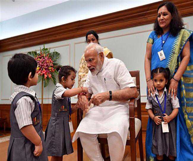 PM Modi bowls over girl students who tie ''rakhi'' to him