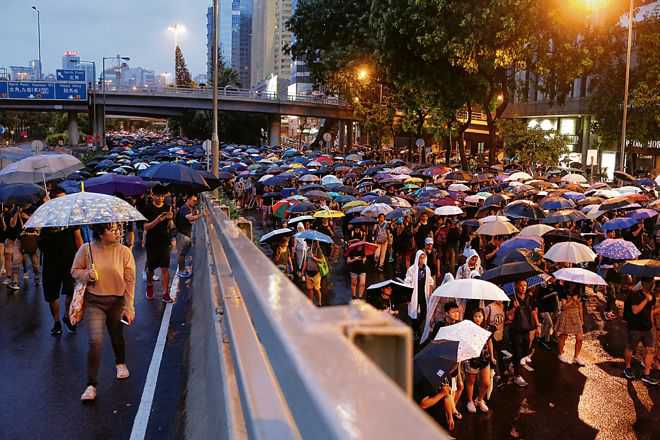 Rain no deterrent, HK protesters flood streets