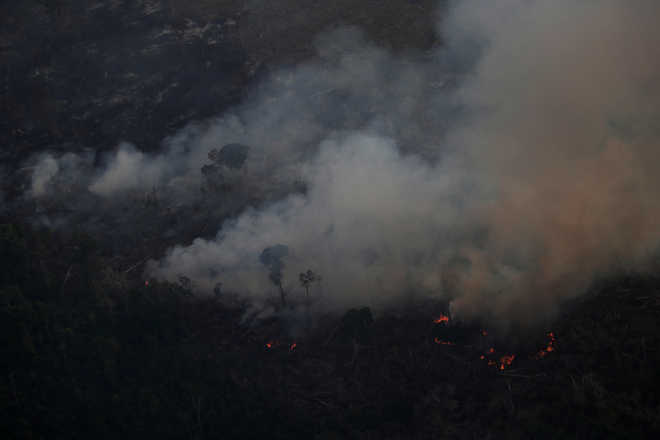 As Amazon fires rage, Brazil’s President Bolsonaro blames NGOs