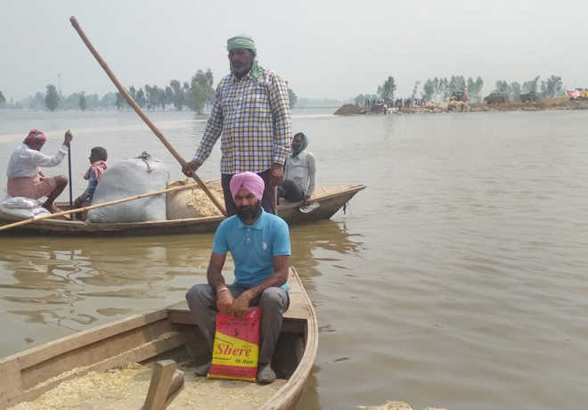 He commutes by boat to take classes in flood-affected village